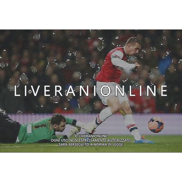 (140125) -- LONDON, Jan. 25, 2014 () -- Lukas Podolski (R) of Arsenal scores his first goal after passing Joe Murphy, the goalie of Coventry City during FA Cup Fourth Round match between Arsenal and Coventry City at Emirates Stadium in London, Britain on Jan. 24, 2014. Arsenal won 4-0. (/Wang Lili) FOR EDITORIAL USE ONLY. NOT FOR SALE FOR MARKETING OR ADVERTISING CAMPAIGNS. NO USE WITH UNAUTHORIZED AUDIO, VIDEO, DATA, FIXTURE LISTS, CLUBLEAGUE LOGOS OR LIVE SERVICES. ONLINE IN-MATCH USE LIMITED TO 45 IMAGES, NO VIDEO EMULATION. NO USE IN BETTING, GAMES OR SINGLE CLUBLEAGUEPLAYER PUBLICATIONS. AG ALDO LIVERANI SAS ONLY ITALY