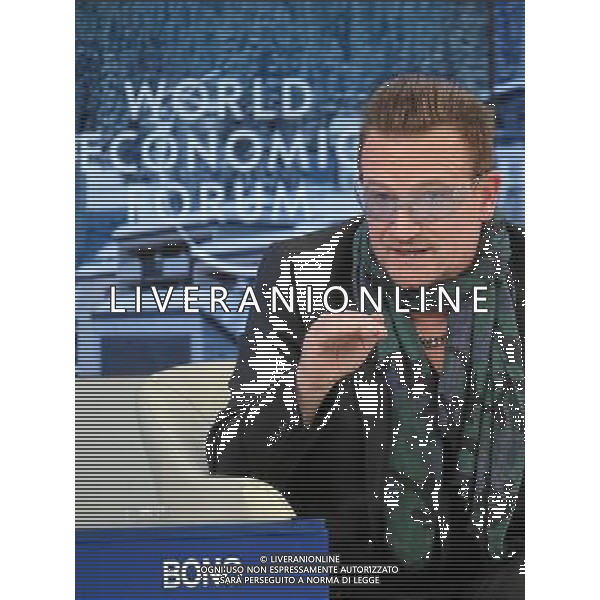 Bono, Lead Singer, U2; Co-Founder, (RED); Co-Founder, ONE, Ireland gestures during the session \'The Post-2015 Goals: Inspiring a New Generation to Act\' at the Annual Meeting 2014 of the World Economic Forum at the congress centre in Davos, January 24, 2014. WORLD ECONOMIC FORUM/swiss-image.ch/Photo Remy Steinegger AG ALDO LIVERANI SAS ONLY ITALY