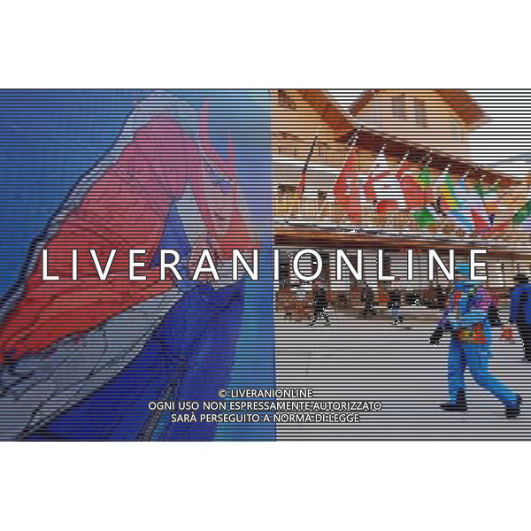 (140204) -- SOCHI, Feb. 4, 2014 () -- People walk past a poster in the mountain olympic village in Sochi, Russia, Feb 3, 2014. The opening ceremony for the 2014 Winter Olympics will kick off on Feb. 7 in Sochi. (/Wang Song) ©PHOTOSHOT/AGENZIA ALDO LIVERANI SAS - ITALY ONLY - Preparativi in occasione della cerimonia di apertura delle Olimpiadi invernali del 2014, che avranno inizio il 7 febbraio a Sochi, in Russia, 4 Febbraio 2014.