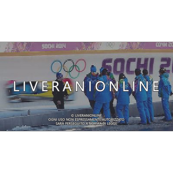 (140205) -- SOCHI, Feb. 5, 2014 () -- Staff look on as a bobsleigh passes by during a training ahead of Sochi 2014 Olympic Winter Games in Sochi, Feb. 4, 2014. (/Fei Maohua) ©photoshot/AGENZIA ALDO LIVERANI SAS - ITALY ONLY - Preparativi delle piste da sci e allenamento in previsione della cerimonia di apertura delle Olimpiadi invernali, Giochi Olimpici Invernali di Sochi, Russia 5 febbraio 2014.