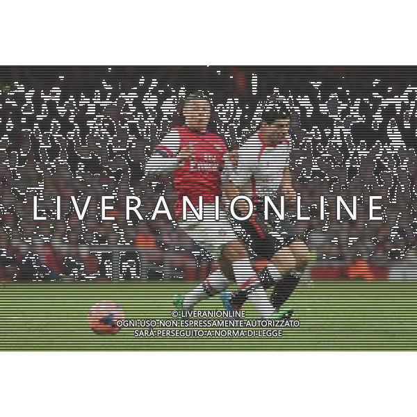 Arsenal\'s Alex Oxlade-Chamberlain brings down Liverpool\'s Luis Suarez Photo by Kieran Galvin/CameraSport Football - FA Challenge Cup Fifth Round - Arsenal v Liverpool - Sunday 16th February 2014 - Emirates Stadium - London © CameraSport - 43 Linden Ave. Countesthorpe. Leicester. England. LE8 5PG - Tel: +44 (0) 116 277 4147 - admin@camerasport.com - www.camerasport.com AG ALDO LIVERANI SAS ONLY ITALY