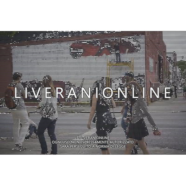 Hipsters walk by an advertisement for Bacardi being painted on a wall in the trendy hipster Williamsburg neighborhood of Brooklyn in New York on Saturday, June 8, 2013. Filmmaker Spike Lee recently spoke against gentrification by hipsters in various gentrifying neighborhoods. Œ Richard B. Levine) ©PHOTOSHOT/AGENZIA ALDO LIVERANI SAS - ITALY ONLY - EDITORIAL USE ONLY