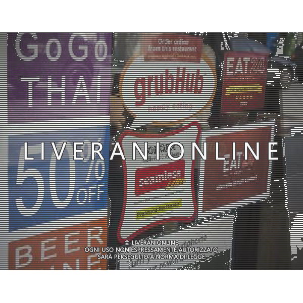 Stickers for Seamless and GrubHub internet food delivery services are seen on the window of a restaurant in Chelsea in New York on Tuesday, May 21, 2013. The two internet companies announced that they will merge pending regulatory approval. GrubHub and Seamless contract with restaurants, post their menus, and take a bite out of the delivery orders.Other services that are in the same business are and Eat24. ©PHOTOSHOT/AGENZIA ALDO LIVERANI SAS - ITALY ONLY - EDITORIAL USE ONLY