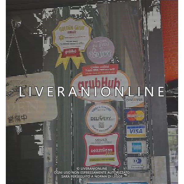 Stickers for Seamless and GrubHub internet food delivery services are seen on the window of a restaurant in Greenwich Village in New York on Tuesday, May 21, 2013. The two internet companies announced that they will merge pending regulatory approval. GrubHub and Seamless contract with restaurants, post their menus, and take a bite out of the delivery orders.Other services that are in the same business are and Eat24. ©PHOTOSHOT/AGENZIA ALDO LIVERANI SAS - ITALY ONLY - EDITORIAL USE ONLY