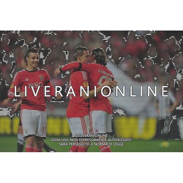 (140228) -- LISBON, Feb. 28, 2014 () -- Players of Benfica celebrate after scoring during the UEFA Europa League round of 32 second-leg football match between Benfica and PAOK Thessaloniki of Greece at the Luz stadium in Lisbon, capital of Portugal, on Feb. 27, 2014. Benfica defeated PAOK 3-0 to go through 4-0 on aggregate. (/Zhang Liyun) (hy) AG ALDO LIVERANI SAS ONLY ITALY