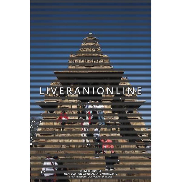 (140309) -- MADHYA PRADESH, March 9, 2014 () -- Tourists visit the Khajuraho group of monuments in Madhya Pradesh of India, March 8, 2014. The Khajuraho group of monuments, or the temples at Khajuraho in Madhya Pradesh of India, were built during the Chandella dynasty, which reached its apogee between 950 and 1050. Only about 20 temples remain; they fall into three distinct groups and belong to two different religions -- Hinduism and Jainism. They strike a perfect balance between architecture and sculpture. The temples at Khajuraho are decorated with a profusion of sculptures showing details of life of ancient people and are among the greatest masterpieces of Indian art. The Khajuraho group of monuments were recognized as the world cultural heritage by the UNESCO in 1986. (/Zheng Huansong) ©photohsot/AGENZIA ALDO LIVERANI SAS - ITALY ONLY - i monumenti, templi di Khajuraho o il Madhya Pradesh appartengono a due diverse religioni - induismo e il giainismo e sono tra i piu\' grandi capolavori dell\'arte indiana, riconosciuti come patrimonio culturale mondiale dall\'UNESCO nel 1986