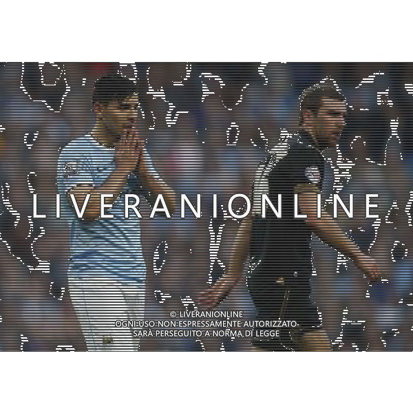 (140310) -- MANCHESTER, March 10, 2014 () -- Sergio Aguero (L) of Manchester City reacts after missing a goal during FA Cup quarterfinal match between Manchester City and Wigan at Etihad Stadium in Manchester, Britain on March 9, 2014. Manchester City lost 1-2. (/Wang Lili) FOR EDITORIAL USE ONLY. NOT FOR SALE FOR MARKETING OR ADVERTISING CAMPAIGNS. NO USE WITH UNAUTHORIZED AUDIO, VIDEO, DATA, FIXTURE LISTS, CLUBLEAGUE LOGOS OR LIVE SERVICES. ONLINE IN-MATCH USE LIMITED TO 45 IMAGES, NO VIDEO EMULATION. NO USE IN BETTING, GAMES OR SINGLE CLUBLEAGUEPLAYER PUBLICATIONS. AG ALDO LIVERANI SAS ONLY ITALY