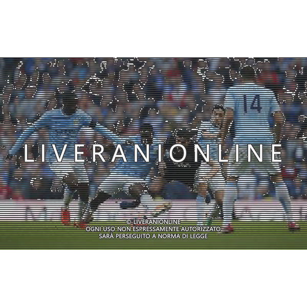 (140310) -- MANCHESTER, March 10, 2014 () -- Yaya Toure (1st, L), Micah Richards (2nd, L) and Jes® s Navas (2nd, R) of Manchester City block Jordi Gomez (C) of Wigan during FA Cup quarterfinal match at Etihad Stadium in Manchester, Britain on March 9, 2014. Manchester City lost 1-2. (/Wang Lili) FOR EDITORIAL USE ONLY. NOT FOR SALE FOR MARKETING OR ADVERTISING CAMPAIGNS. NO USE WITH UNAUTHORIZED AUDIO, VIDEO, DATA, FIXTURE LISTS, CLUBLEAGUE LOGOS OR LIVE SERVICES. ONLINE IN-MATCH USE LIMITED TO 45 IMAGES, NO VIDEO EMULATION. NO USE IN BETTING, GAMES OR SINGLE CLUBLEAGUEPLAYER PUBLICATIONS. AG ALDO LIVERANI SAS ONLY ITALY