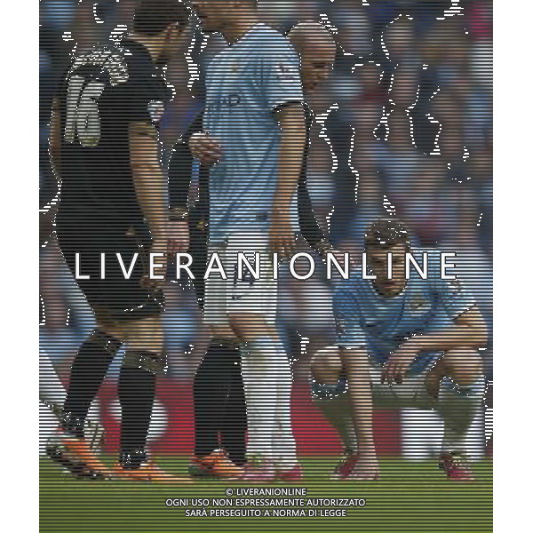 (140310) -- MANCHESTER, March 10, 2014 () -- Edin Dzeko (1st, R) of Manchester City reacts during FA Cup quarterfinal match between Manchester City and Wigan at Etihad Stadium in Manchester, Britain on March 9, 2014. Manchester City lost 1-2. (/Wang Lili) FOR EDITORIAL USE ONLY. NOT FOR SALE FOR MARKETING OR ADVERTISING CAMPAIGNS. NO USE WITH UNAUTHORIZED AUDIO, VIDEO, DATA, FIXTURE LISTS, CLUBLEAGUE LOGOS OR LIVE SERVICES. ONLINE IN-MATCH USE LIMITED TO 45 IMAGES, NO VIDEO EMULATION. NO USE IN BETTING, GAMES OR SINGLE CLUBLEAGUEPLAYER PUBLICATIONS. AG ALDO LIVERANI SAS ONLY ITALY
