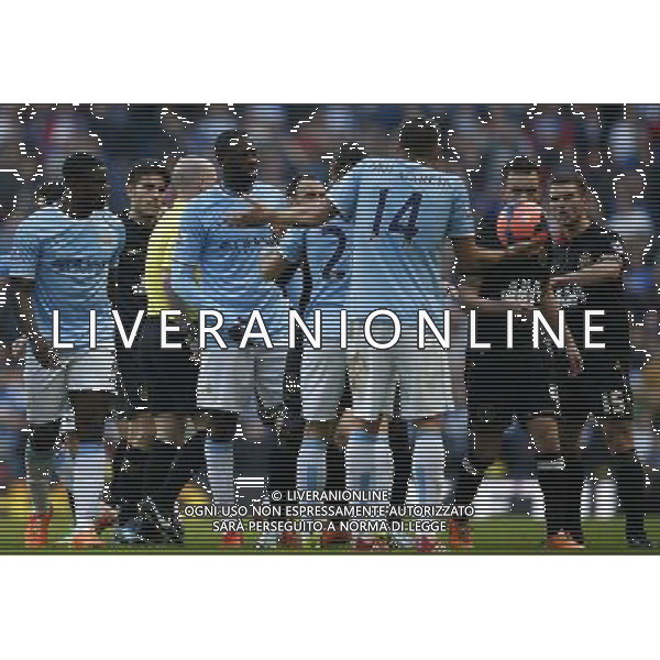 (140310) -- MANCHESTER, March 10, 2014 () -- Players of Manchester City argue with players of Wigan during FA Cup quarterfinal match between Manchester City and Wigan at Etihad Stadium in Manchester, Britain on March 9, 2014. Manchester City lost 1-2. (/Wang Lili) FOR EDITORIAL USE ONLY. NOT FOR SALE FOR MARKETING OR ADVERTISING CAMPAIGNS. NO USE WITH UNAUTHORIZED AUDIO, VIDEO, DATA, FIXTURE LISTS, CLUBLEAGUE LOGOS OR LIVE SERVICES. ONLINE IN-MATCH USE LIMITED TO 45 IMAGES, NO VIDEO EMULATION. NO USE IN BETTING, GAMES OR SINGLE CLUBLEAGUEPLAYER PUBLICATIONS. AG ALDO LIVERANI SAS ONLY ITALY