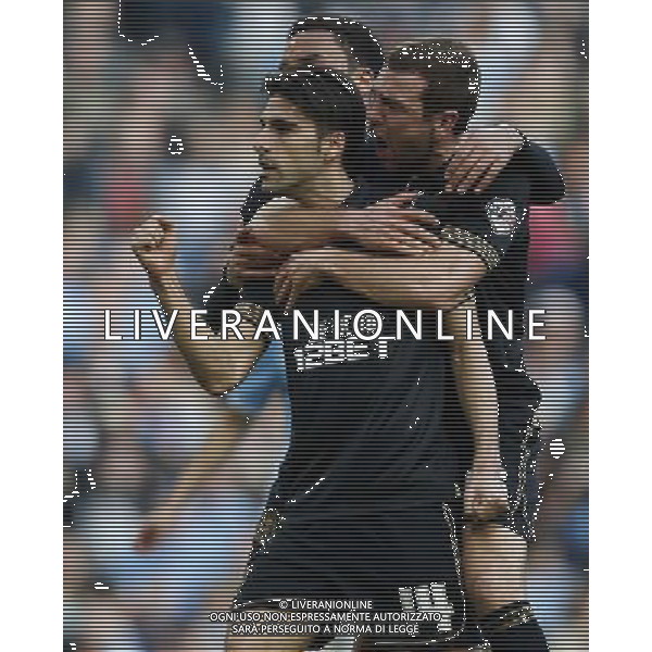 (140310) -- MANCHESTER, March 10, 2014 () -- Jordi Gomez (C) of Wigan celebrates scoring their team\'s first goal from the penalty spot with teammates after FA Cup quarterfinal match between Manchester City and Wigan at Etihad Stadium in Manchester, Britain on March 9, 2014. Wigan won 2-1. (/Wang Lili) FOR EDITORIAL USE ONLY. NOT FOR SALE FOR MARKETING OR ADVERTISING CAMPAIGNS. NO USE WITH UNAUTHORIZED AUDIO, VIDEO, DATA, FIXTURE LISTS, CLUBLEAGUE LOGOS OR LIVE SERVICES. ONLINE IN-MATCH USE LIMITED TO 45 IMAGES, NO VIDEO EMULATION. NO USE IN BETTING, GAMES OR SINGLE CLUBLEAGUEPLAYER PUBLICATIONS. AG ALDO LIVERANI SAS ONLY ITALY