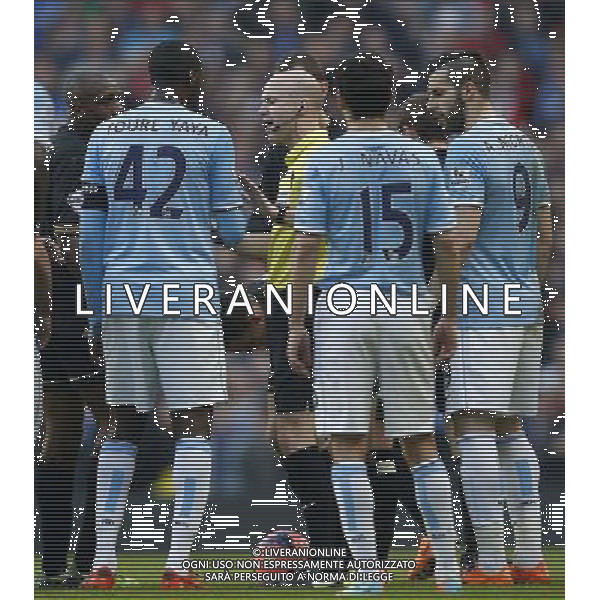 (140310) -- MANCHESTER, March 10, 2014 () -- Referee Anthony Taylor (C) cools down the intense situation between plyers of Manchester City and Wigan during their FA Cup quarterfinal match at Etihad Stadium in Manchester, Britain on March 9, 2014. Manchester City lost 1-2. (/Wang Lili) FOR EDITORIAL USE ONLY. NOT FOR SALE FOR MARKETING OR ADVERTISING CAMPAIGNS. NO USE WITH UNAUTHORIZED AUDIO, VIDEO, DATA, FIXTURE LISTS, CLUBLEAGUE LOGOS OR LIVE SERVICES. ONLINE IN-MATCH USE LIMITED TO 45 IMAGES, NO VIDEO EMULATION. NO USE IN BETTING, GAMES OR SINGLE CLUBLEAGUEPLAYER PUBLICATIONS. AG ALDO LIVERANI SAS ONLY ITALY