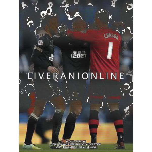 (140310) -- MANCHESTER, March 10, 2014 () -- Scott Carson (R), goalie of Wigan celebrates victory with teammates James Perch (L) and Stephen Crainey after FA Cup quarterfinal match between Manchester City and Wigan at Etihad Stadium in Manchester, Britain on March 9, 2014. Wigan won 2-1. (/Wang Lili) FOR EDITORIAL USE ONLY. NOT FOR SALE FOR MARKETING OR ADVERTISING CAMPAIGNS. NO USE WITH UNAUTHORIZED AUDIO, VIDEO, DATA, FIXTURE LISTS, CLUBLEAGUE LOGOS OR LIVE SERVICES. ONLINE IN-MATCH USE LIMITED TO 45 IMAGES, NO VIDEO EMULATION. NO USE IN BETTING, GAMES OR SINGLE CLUBLEAGUEPLAYER PUBLICATIONS. AG ALDO LIVERANI SAS ONLY ITALY
