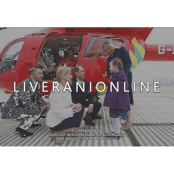 Britain\'s Prince Edward, his wife Sophie, Countess of Wessex and the chief executive of London\'s Air Ambulance Graham Hodgkin (L) crouch as they speak to Iris Filbee, 7, and her mother Sarah at the Royal Hospital in east London March 10, 2014. Prince Edward celebrated his 50th birthday on Monday by visiting the headquarters of London\'s Air Ambulance. Iris was treated by doctors and paramedics from the London Air Ambulance after an accident. ©PHOTOSHOT/AGENZIA ALDO LIVERANI SAS - ITALY ONLY - REALI INGLESI: Il principe Edward esua moglie Sophie, contessa di Wessex presso il Royal Hospital nella zona est di Londra
