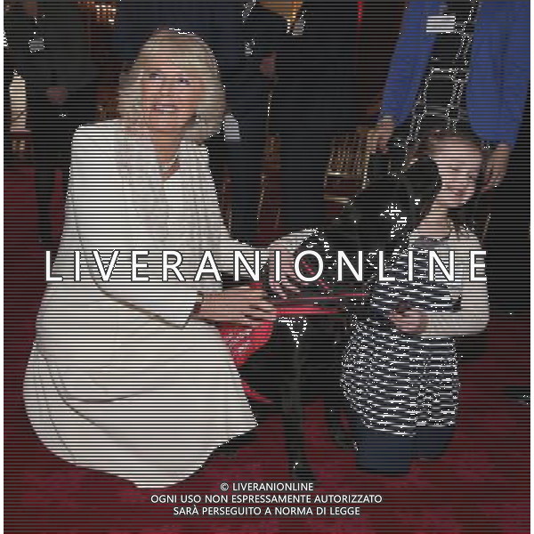 LONDON, ENGLAND - MARCH 11: Camilla, Duchess of Cornwall laughs as 6 year old Cerys Davies (who has type 1 diabetes) is licked by her detection dog Wendy at St James\'s Palace on March 11, 2014 in London, England. ©photoshot/AGENZIA ALDO LIVERANI SAS - ITALY ONLY - REALI INGLESI: Il Principe Carlo e Camilla Duchessa di Cornovaglia durante una dimostrazione di cani rilevazione mediche a Palazzo San Giacomo il 11 Marzo 2014 a Londra, Inghilterra. 
