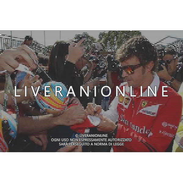 Fernando Alonso (ESP) Ferrari signs autographs for the fans. 14.03.2014. Formula 1 World Championship, Rd 1, Australian Grand Prix, Albert Park, Melbourne, Australia, Practice Day. - www.xpbimages.com, EMail: requests@xpbimages.com - copy of publication required for printed pictures. Every used picture is fee-liable. © Copyright: Moy / XPB Images /Ag. Aldo Liverani s.a.s.-Only Italy-Editorial Use Only