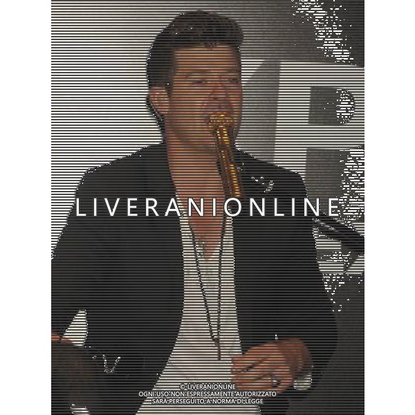 Singer Robin Thicke performs during the grand opening of EXPRESS Times Square on March 25, 2014 in New York City. ©photohsot/AGENZIA ALDO LIVERANI SAS - ITALY ONLY - EDITORIAL USE ONLY