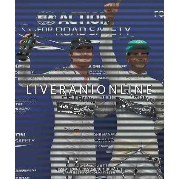 (140329) -- SEPANG, March 29, 2014 () -- Mercedes driver Lewis Hamilton (R) of Britain celebrates with Mercedes Formula one driver Nico Rosberg of Germany after taking the pole position after the qualifying session for the Malaysian Formula One Grand Prix at Sepang International Circuit in Sepang, Malaysia, March 29, 2014. (/Chong Voon Chung) AG ALDOL IVERANI SAS ONLY ITALY