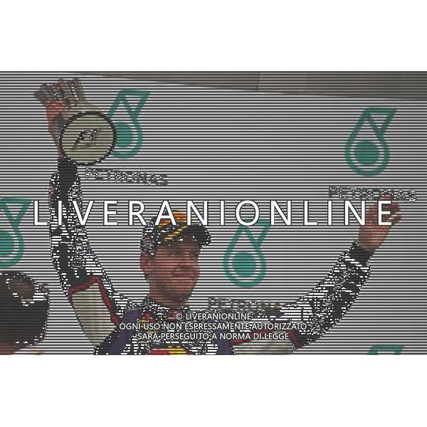 Sebastian Vettel (GER) Red Bull Racing celebrates his third position on the podium. 30.03.2014. Formula 1 World Championship, Rd 2, Malaysian Grand Prix, Sepang, Malaysia, Sunday. - www.xpbimages.com, EMail: requests@xpbimages.com - copy of publication required for printed pictures. Every used picture is fee-liable. Â© Copyright: Photo4 / XPB Images AG ALDO LIVERANI SAS ONLY ITALY
