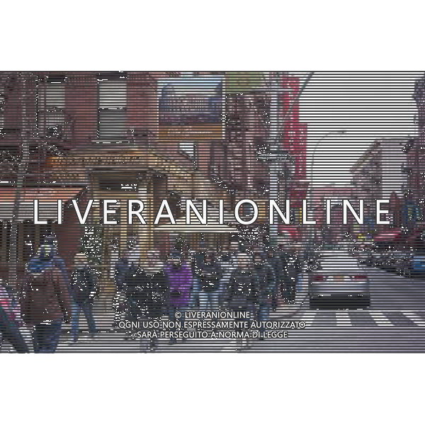 A tour group walks along Mulberry Street in the Little Italy neighborhood of New York on Sunday, March 30, 2014. Changing demographics and sharp rent increases have decimated the Little Italy neighborhood reducing the once thriving Italian enclave from a fifty-block area into a short three blocks mostly populated by tourist oriented businesses. Eight restaurants have closed in the past year as their leases came up and negotiations with landlords were fruitless. As Chinatown moves north many Italian businesses had been displaced by businesses catering to their Asian customers. ©photoshot/AGENZIA ALDO LIVERANI SAS - ITALY ONLY - Vedute della citta\' di New York - Vita quotidiana