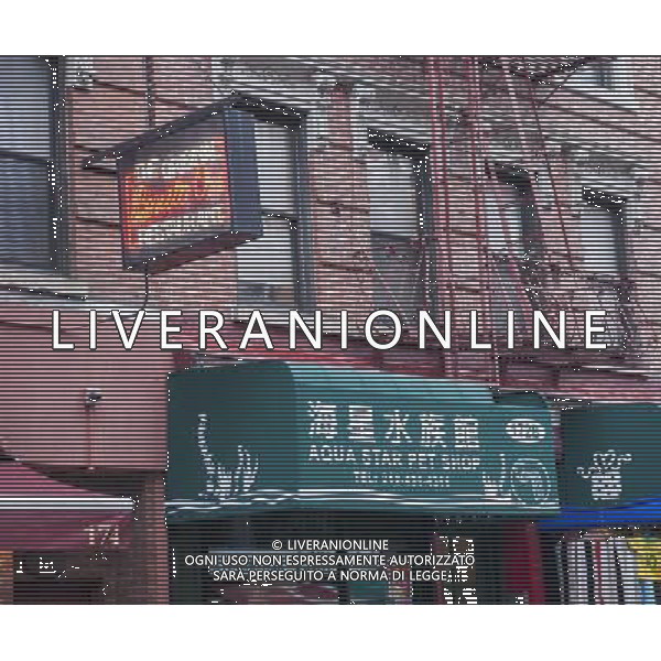 An Italian restaurant next to an Asian business along Mulberry Street in the Little Italy neighborhood of New York on Sunday, March 30, 2014. Changing demographics and sharp rent increases have decimated the Little Italy neighborhood reducing the once thriving Italian enclave from a fifty-block area into a short three blocks mostly populated by tourist oriented businesses. Eight restaurants have closed in the past year as their leases came up and negotiations with landlords were fruitless. As Chinatown moves north many Italian businesses had been displaced by businesses catering to their Asian customers. ©photoshot/AGENZIA ALDO LIVERANI SAS - ITALY ONLY - Vedute della citta\' di New York - Vita quotidiana