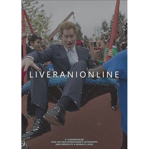 Prince Harry on a swing with local school children from Gainsborough Primary school in Newham at the new Queen Elizabeth Olympic Park, with the Mayor of London, Boris Johnson. The park will open to the public on Saturday 5th April. 14 ©photoshot/AGENZIA ALDO LIVERANI SAS - ITALY ONLY - EDITORIAL USE ONLY - REALI INGLESI: Il principe Harry d\'inghilterra con i bambini delle scuole locali da Gainsborough a Newham presso il nuovo Parco Olimpico Queen Elizabeth, con il sindaco di Londra, Boris Johnson