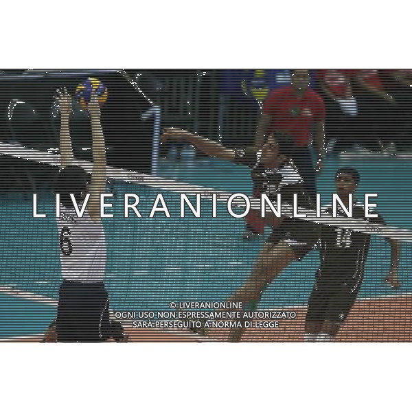 (140409) -- PASAY CITY, April 9, 2014 () -- Khalid Almaqbali (C) of Oman spikes the ball during the preliminary round of the 2014 Asian Men\'s Club Volleyball Championship against Hong Kong of China in Pasay City, the Philippines, April 9, 2014. Oman won 3-1. (/Rouelle Umali) AG ALDO LIVERANI SAS ONLY ITALY