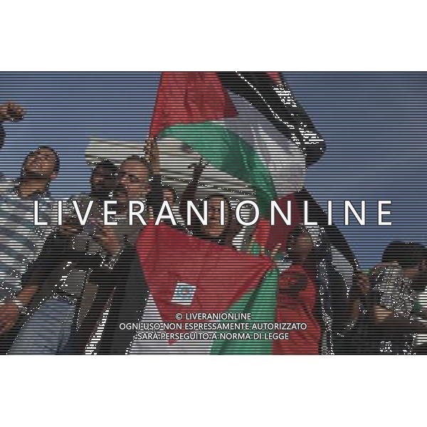 (140423) -- GAZA, April 23, 2014 () -- Palestinians wave Palestinian flags as they gather to celebrate a newly made reconciliation deal between the Palestine Liberation Organization (PLO) and the Hamas to end their seven-year split, in Gaza City, on April 23, 2014. Palestinian President Mahmoud Abbas said on Wednesday that the reconciliation deal reached with his rival Hamas movement will empower the principle of the two-state solution. (/Wissam Nassar) ©PHOTOHSOT/AGENZIA ALDO LIVERANI SAS - ITALY ONLY - EDITORIAL USE ONLY - Celebrazione per l\'accordo di riconciliazione recentemente stipulato tra l\'Organizzazione Liberazione della Palestina (OLP) e Hamas, a Gaza City, il 23 aprile 2014.