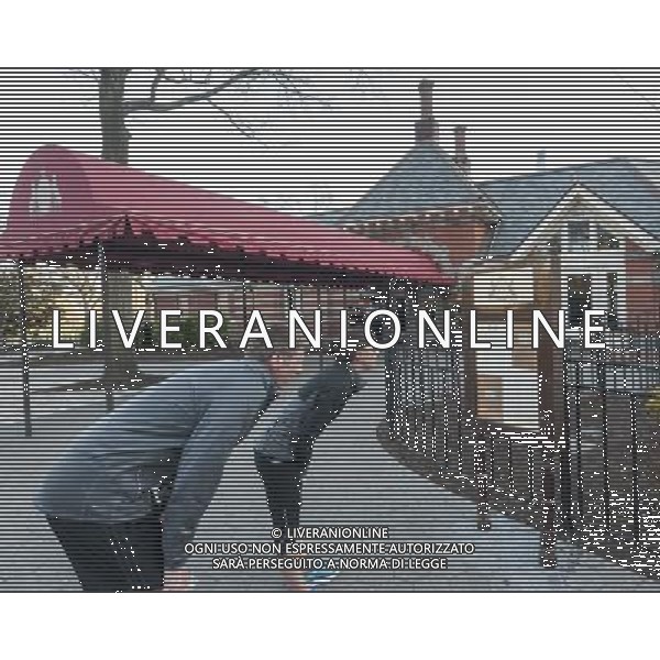 Central Park runners stop by to inspect the menu of the newly reopened Tavern on the Green in New York on opening day, Thursday, April 24, 2014. After being closed for four years the iconic restaurant reopens with new management, a new menu and a $30 million renovation. The new owners are Jim Caiola and David Salama, restaurateurs from Philadelphia. At one time the original restaurant was the second highest grossing eatery in the U.S. The new renovation provides fewer seats and a more subdued decor with food created by a local chef, Katy Sparks. ©PHOTOSHOT/AGENZIA ALDO LIVERANI SAS - ITALY ONLY - EDITORIAL USE ONLY - Vedute della citta\' di New York - Vita quotidiana