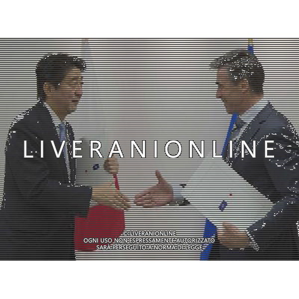 Japan\'s Prime Minister Shinzo Able, left, shakes hands with NATO Secretary General Anders Fogh Rasmussen prior to a meeting at NATO headquarters in Brussels on Tuesday, May 6, 2014. Abe will, in a two-day visit, meet with NATO, EU and Belgian officials. (AP Photo/Virginia Mayo) AG ALDO LIVERANI SAS ONLY ITALY