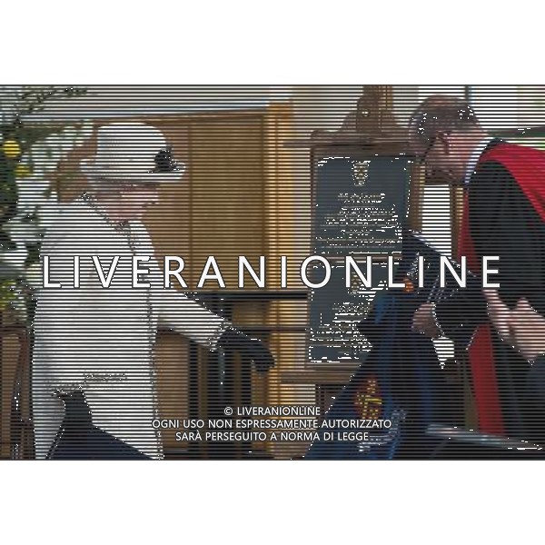 FELSTED, ENGLAND - MAY 06: Queen Elizabeth II unveils a plaque during an official visit to Felsted School on May 6, 2014 in Felsted, England. Her Majesty unveiled two plaques to commemorate the School\'s 450th anniversary and completion of a new boarding house. AG ALDO LIVERANI SAS ONLY ITALY
