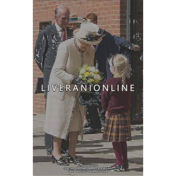 FELSTED, ENGLAND - MAY 06: Prince Phillip, Duke of Edinburgh and Queen Elizabeth II receives flowers during an official visit to Felsted School on May 6, 2014 in Felsted, England. Her Majesty unveiled two plaques to commemorate the School\'s 450th anniversary and completion of a new boarding house. AG ALDO LIVERANI SAS ONLY ITALY