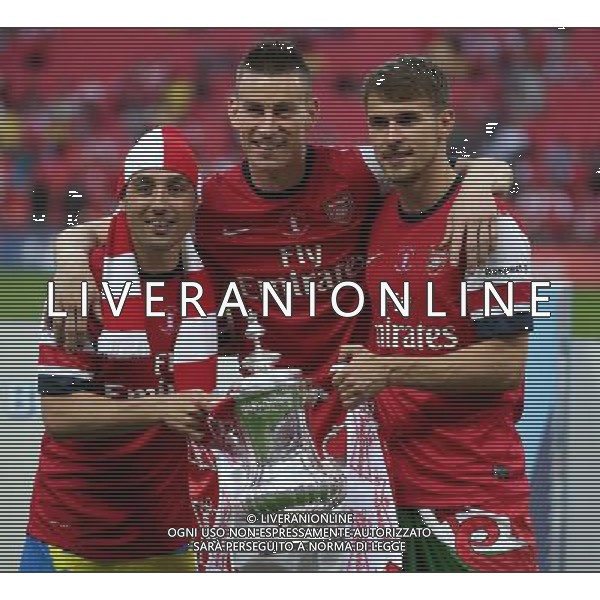 L-R Santi Cazorla Of Arsenal Laurent Koscielny Of Arsenal and Aaron Ramsey Of Arsenal with Trophy Photographer Kieran Galvin/CameraSport Football - FA Challenge Cup Final - Arsenal v Hull City - Saturday 17th May 2014 - Wembley Stadium - London Â© CameraSport - 43 Linden Ave. Countesthorpe. Leicester. England. LE8 5PG - Tel: +44 (0) 116 277 4147 - admin@camerasport.com - www.camerasport.com AG ALDOL IVERANI SAS ONLY ITALY