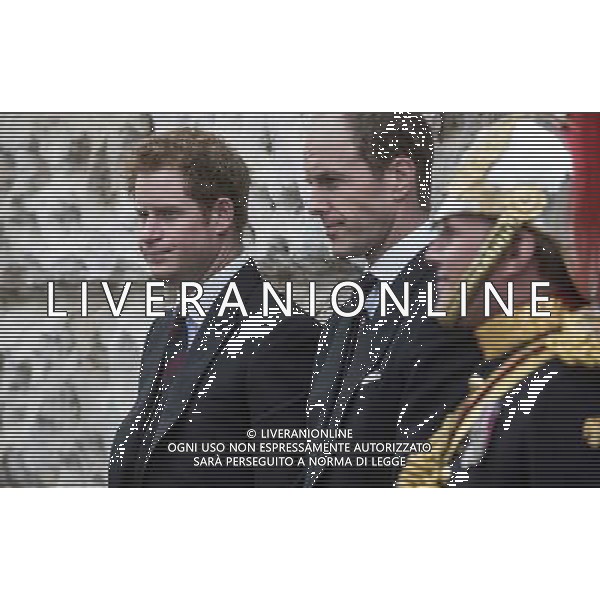 Prince Harry, a former officer in the household cavalry, watches the The new Standards of the household cavalry as they are paraded during the ceremony on horse guards parade. The Queen presents the Household Cavalry with new standards once every decade. The Household Cavalry consists of the two senior regiments in the British Army; The Life Guards and The Blues and Royals. These two regiments form the Sovereign’s personal mounted body guard while also providing an operational Armoured Cavalry Regiment, equipped with CVR(T) vehicles. This parade sees the entire regiment, both mounted on horses and in armoured vehicles being inspected by Her Majesty on Horse Guards Parade. The Household Cavalry Regiment has recently returned from its last tour to Afghanistan having had six deployments since 2004. The Standards themselves have historically acted as a rallying point during battle and now carry all of the Battle Honours of both The Life Guards and The Blues and Royals. They carry huge significance as they represent four hundred years of history of service to the monarch and to the country. The Parade will begin with the Armoured Regiment and the Mounted Regiment forming up on Horse Guards Parade, when the outgoing standards are trooped and removed from the parade. ©PHOTOSHOT/Agenzia Aldo Liverani sas - ITALY ONLY - EDITORIAL USE ONLY ©photoshot/Agenzia Aldo Liverani sas - ITALY ONLY - REALI INGLESI: La Regina Elisabetta II d\'inghilterra e il principe Harry, durante la cerimonia per la parata delle guardie a cavallo
