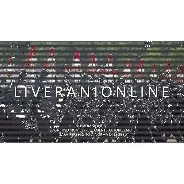 The House hold cavalry parade in from of the Queen following the presentation of their new standards. A ceremony that takes place once every decade. The Household Cavalry consists of the two senior regiments in the British Army; The Life Guards and The Blues and Royals. These two regiments form the Sovereign\'s personal mounted body guard while also providing an operational Armoured Cavalry Regiment, equipped with CVR(T) vehicles. This parade sees the entire regiment, both mounted on horses and in armoured vehicles being inspected by Her Majesty on Horse Guards Parade. The Household Cavalry Regiment has recently returned from its last tour to Afghanistan having had six deployments since 2004. The Standards themselves have historically acted as a rallying point during battle and now carry all of the Battle Honours of both The Life Guards and The Blues and Royals. They carry huge significance as they represent four hundred years of history of service to the monarch and to the country. The Parade will begin with the Armoured Regiment and the Mounted Regiment forming up on Horse Guards Parade, when the outgoing standards are trooped and removed from the parade. ©PHOTOSHOT/Agenzia Aldo Liverani sas - ITALY ONLY - EDITORIAL USE ONLY ©photoshot/Agenzia Aldo Liverani sas - ITALY ONLY - REALI INGLESI: La Regina Elisabetta II d\'inghilterra e il principe Harry, durante la cerimonia per la parata delle guardie a cavallo