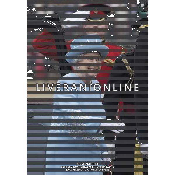 The Queen arrives on horse guards to present the Household Cavalry with their anew standard ceremony that takes place once every decade. The Household Cavalry consists of the two senior regiments in the British Army; The Life Guards and The Blues and Royals. These two regiments form the SovereignÇƒÙs personal mounted body guard while also providing an operational Armoured Cavalry Regiment, equipped with CVR(T) vehicles. This parade sees the entire regiment, both mounted on horses and in armoured vehicles being inspected by Her Majesty on Horse Guards Parade. The Household Cavalry Regiment has recently returned from its last tour to Afghanistan having had six deployments since 2004. The Standards themselves have historically acted as a rallying point during battle and now carry all of the Battle Honours of both The Life Guards and The Blues and Royals. They carry huge significance as they represent four hundred years of history of service to the monarch and to the country. The Parade will begin with the Armoured Regiment and the Mounted Regiment forming up on Horse Guards Parade, when the outgoing standards are trooped and removed from the parade. ©photoshot/Agenzia Aldo Liverani sas - ITALY ONLY - REALI INGLESI: La Regina Elisabetta II d\'inghilterra e il principe Harry, durante la cerimonia per la parata delle guardie a cavallo