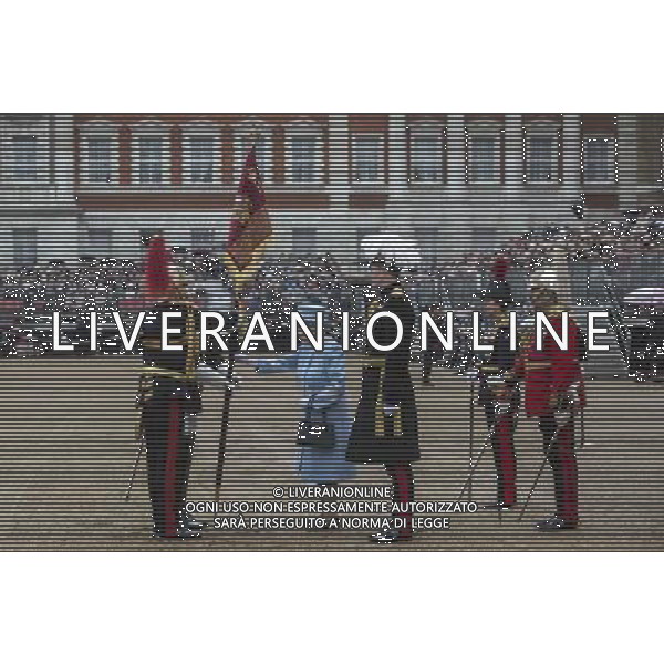The Queen touches the pole carrying the house hold cavalry\'s new standard as she\'s presents them with their new standard during the ceremony that takes place once every decade. The Household Cavalry consists of the two senior regiments in the British Army; The Life Guards and The Blues and Royals. These two regiments form the SovereignÇƒÙs personal mounted body guard while also providing an operational Armoured Cavalry Regiment, equipped with CVR(T) vehicles. This parade sees the entire regiment, both mounted on horses and in armoured vehicles being inspected by Her Majesty on Horse Guards Parade. The Household Cavalry Regiment has recently returned from its last tour to Afghanistan having had six deployments since 2004. The Standards themselves have historically acted as a rallying point during battle and now carry all of the Battle Honours of both The Life Guards and The Blues and Royals. They carry huge significance as they represent four hundred years of history of service to the monarch and to the country. The Parade will begin with the Armoured Regiment and the Mounted Regiment forming up on Horse Guards Parade, when the outgoing standards are trooped and removed from the parade. ©photoshot/Agenzia Aldo Liverani sas - ITALY ONLY - REALI INGLESI: La Regina Elisabetta II d\'inghilterra e il principe Harry, durante la cerimonia per la parata delle guardie a cavallo