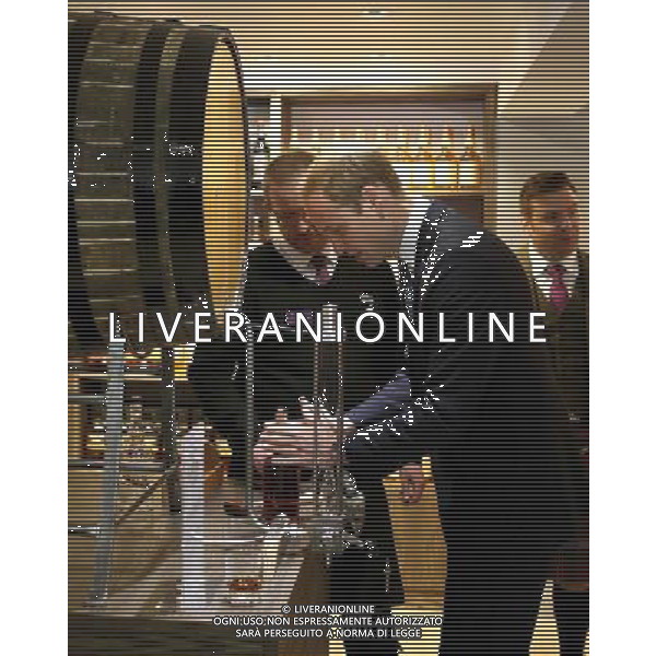 The Duke of Cambridge puts a label on a bottle of Glenturret Single Malt whisky which he decanted from a barrel with help from Andrew Sveistrup (left), shop stock controller during a tour of The Famous Grouse Distillery in Crieff, Scotland. William and Kate, known as the Earl and Countess of Strathearn north of the border, are touring the Strathearn area in the heart of Scotland. ©PHOTOSHOT/Agenzia Aldo Liverani sas - ITALY ONLY - EDITORIAL USE ONLY - REALI INGLESI: Il principe Williamd\'inghilterra con la moglie Kate middleton duchessa di Cambridge durante una visita alla famosa distilleria Grouse a Crieff, Scozia.