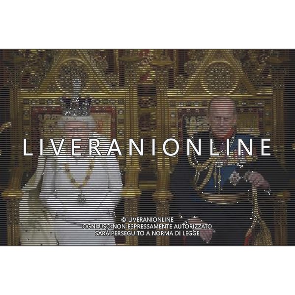 Britain\'s Queen Elizabeth II (L) seated on the Throne in the House of Lords next to Prince Philip, Duke of Edinburgh (R) prepares to deliver the Queen\'s Speech during the State Opening of Parliament at the Palace of Westminster in London on June 4, 2014. The State Opening of Parliament marks the formal start of the parliamentary year and the Queen\'s Speech sets out the government\'s agenda for the coming session. AG ALDO LIVERANI SAS ONLY ITALY