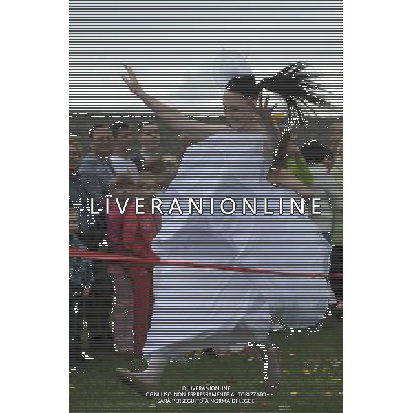 (140607) -- NARVA, June 7, 2014 () -- A woman in a wedding dress touches the finish line in an annual Runaway Brides competition in Narva of Estonia, June 7, 2014. A total of 73 married and single women from Estonia and Russia dressed up as brides raced on a 50-meter grass track here on Saturday. (/Sergei Stepanov) ©PHOTOSHOT/Agenzia Aldo Liverani sas - ITALY ONLY - EDITORIAL USE ONLY - Donne in abiti da sposa competono in un concorso una corsa annuale Runaway Brides in Narva Estonia, 7 giugno 2014