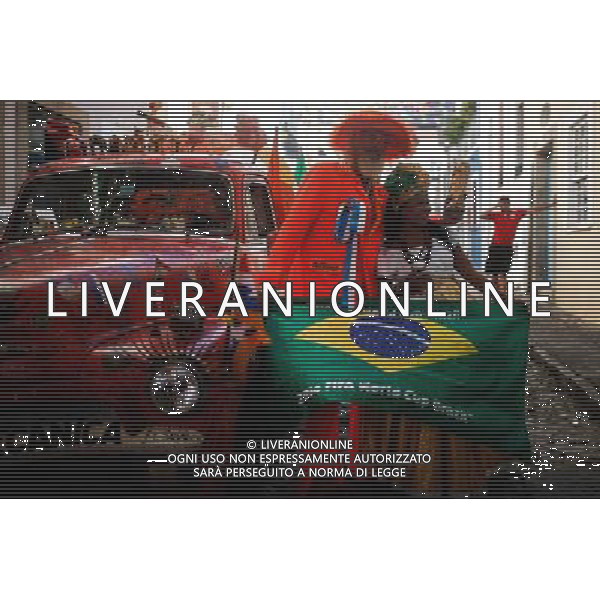 (140611) -- SALVADOR, June 11, 2014 () -- A fan of Holland football team poses for photos with a Brazilian woman in the Pelourihno neighborhood in Salvador, Brazil, on June 11, 2014. The 2014 FIFA World Cup will be held in Brazil from June 12 to July 13.(/Jhon Paz) (rh) ©PHOTOSHOT/Agenzia Aldo Liverani sas - ITALY ONLY - EDITORIAL USE ONLY - Preparativi e attesa dell\'inizio della coppa del mondo FIFA Brasile 2014