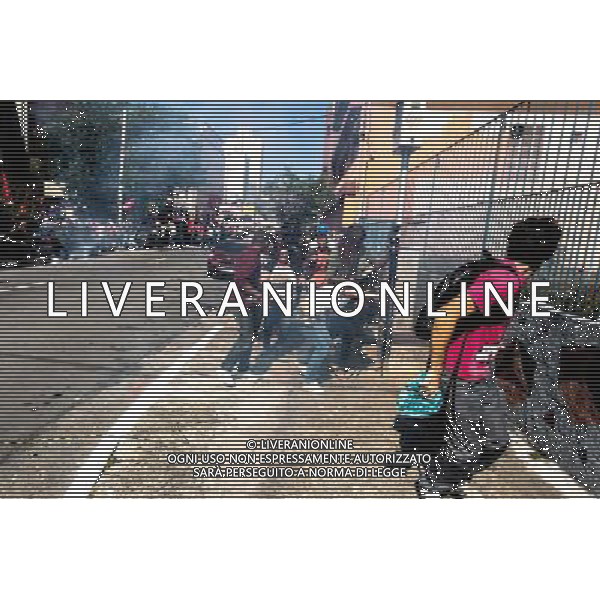 People run from tear gas during a demonstration of social movements in Sao Paulo, Brazil on June 12, 2014. The demonstration happens near the same avenue that leads to the Itaquerao stadium, where it occurs on the same day, the opening match of the World Cup between Brazil and Croatia. (Photo by Tiago Mazza Chiaravalloti/NurPhoto) ©photoshot/Agenzia Aldo Liverani sas - ITALY ONLY - EDITORIAL USE ONLY - Scontri tra manifestanti e polizia durante la manifestazione di Protesta e la dimostrazione dei movimenti sociali a Sao Paulo, in Brasile il 12 giugno 2014 nel giorno della partita inaugurale della Coppa del Mondo Fifa World Cup 