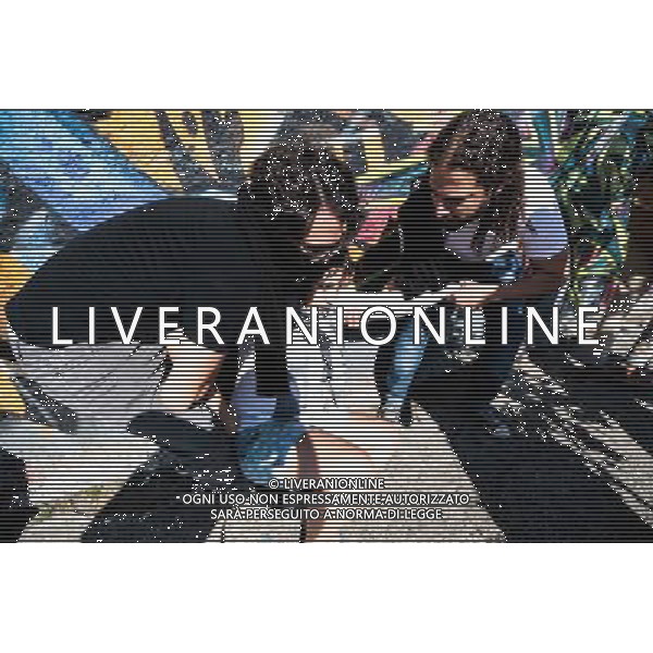 Woman gets sick because of the effects of tear gas thrown by police during a demonstration of social movements in Sao Paulo, Brazil on June 12, 2014. The demonstration happens near the same avenue that leads to the Itaquerao stadium, where it occurs on the same day, the opening match of the World Cup between Brazil and Croatia. (Photo by Tiago Mazza Chiaravalloti/NurPhoto) ©photoshot/Agenzia Aldo Liverani sas - ITALY ONLY - EDITORIAL USE ONLY - Scontri tra manifestanti e polizia durante la manifestazione di Protesta e la dimostrazione dei movimenti sociali a Sao Paulo, in Brasile il 12 giugno 2014 nel giorno della partita inaugurale della Coppa del Mondo Fifa World Cup 