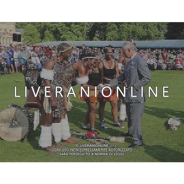 The Prince of Wales, President of the British Red Cross Society meets an African dance group following a performance during a garden party in honour of the society at Buckingham Palace, London. ©photoshot/Agenzia Aldo Liverani sas - ITALY ONLY - EDITORIAL USE ONLY
