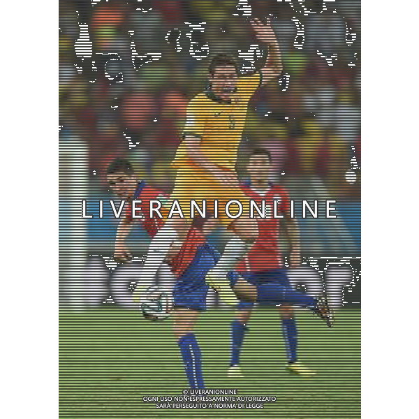 (140613) -- CUIABA, June 13, 2014 () -- Australia\'s Mark Milligan (front) jumps for the ball during a Group B match between Chile and Australia of 2014 FIFA World Cup in the Arena Pantanal Stadium in Cuiaba, Brazil, June 13, 2014. Chile won 3-1 over Australia on Friday. (/Liu Dawei)(pcy) ©PHOTOSHOT/Agenzia Aldo Liverani sas - ITALY ONLY - EDITORIAL USE ONLY - Cile Vs Australia partita del Gruppo B Coppa del mondo FIFA World Cup nel Pantanal stadio Arena di Cuiaba, Brasile, 13 giugno 2014