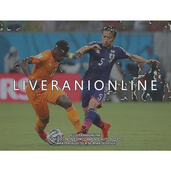 (140614) -- RECIFE, June 14, 2014 () -- Cote d\'Ivoire\'s Serge Aurier vies with Japan\'s Yuto Nagatomo during a Group C match between Cote d\'Ivoire and Japan of 2014 FIFA World Cup in the Aren Pernambuco Stadium in Recife, Brazil, June 14, 2014. (/Cao Can)(rh) ©PHOTOSHOT/Agenzia Aldo Liverani Sas - ITALY ONLY - EDITORIAL USE ONLY - Costa d\'Avorio Vs Giappone partita del Gruppo C della coppa del mondo 2014 FIFA World Cup Stadium Arena Pernambuco a Recife, in Brasile, 14 giugno 2014
