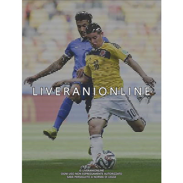 (140614) -- BELO HORIZONTE, June 14, 2014 () -- Colombia\'s James Rodriguez shoots the ball as Greece\'s Panagiotis Kone attempts to interrupt during a Group C match between Colombia and Greece of 2014 FIFA World Cup at the Estadio Mineirao Stadium in Belo Horizonte, Brazil, June 14, 2014. Colombia won 3-0 over Greece on Saturday. (/Qi Heng)(pcy) ©PHOTOSHOT/Agenzia Aldo Liverani sas - ITALY ONLY - EDITORIAL USE ONLY - Colombia Vs Grecia partita del Gruppo C Coppa del Mondo FIFA 2014 Mineirao stadio Estadio a Belo Horizonte, in Brasile 14 Giugno 2014