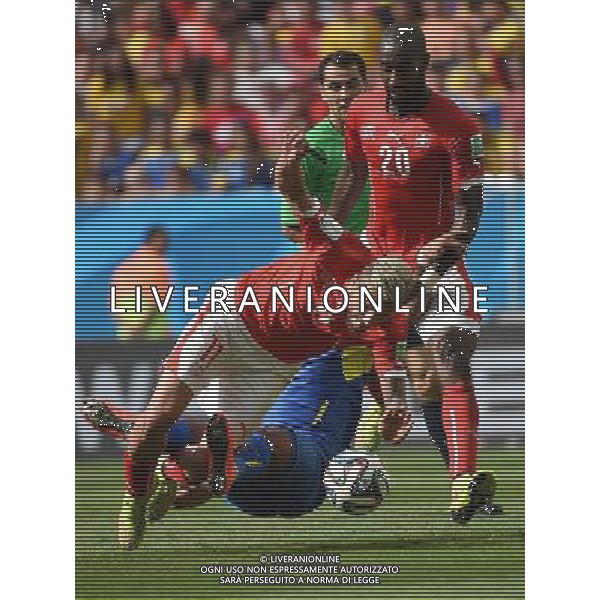 (140615) -- BRASILIA, June 15, 2014 () -- Switzerland\'s Valon Behrami (front) falls down in a competition during a Group E match between Switzerland and Ecuador of 2014 FIFA World Cup at the Estadio Nacional Stadium in Brasilia, capital of Brazil, June 15, 2014. Switzerland won 2-1 over Ecuador on Sunday.(/Liu Dawei)(pcy) ©PHOTOSHOT/Agenzia Aldo Liverani sas - ITALY ONLY - EDITORIAL USE ONLY - SVIZZERA VS ECUADOR partita del Gruppo E Coppa del mondo Fifa allo Stadio nazionale di Brasilia, Brasile, 15 giugno 2014. Svizzera ha vinto per 2-1