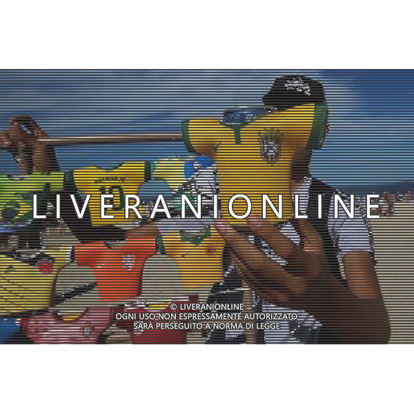 (140614) -- RIO DE JANEIRO, June 14, 2014 () -- A vendor sells souvenirs at Copacabana Beach in Rio de Janeiro, Brazil, June 14, 2014. (/Rahel Patrasso)(rh) ©PHOTOSHOT/Agenzia Aldo Liverani sas - ITALY ONLY - EDITORIAL USE ONLY - Il Brasile ospita la coppa del mondo FIFA World Cup 2014