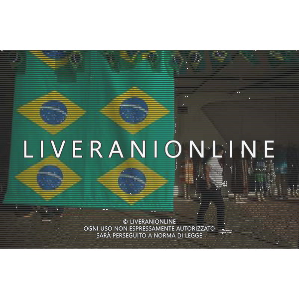 (140614) -- BRASILIA, June 14, 2014 () -- A woman passes by a shop in Brasilia, Brazil,on June 14, 2014. (/Jhon Paz) (rh) ©PHOTOSHOT/Agenzia Aldo Liverani sas - ITALY ONLY - EDITORIAL USE ONLY - Il Brasile ospita la coppa del mondo FIFA World Cup 2014